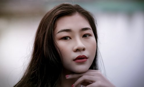 Close-Up Photography Of A Woman With Red Lipstick Smiling photo