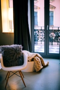Gray Throw Pillow On White Padded Armchair