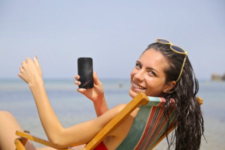 Woman Sitting On Sun Lounger photo