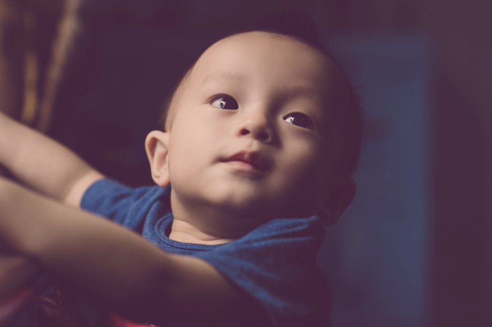 Close-Up Photography Of Baby Looking Up photo