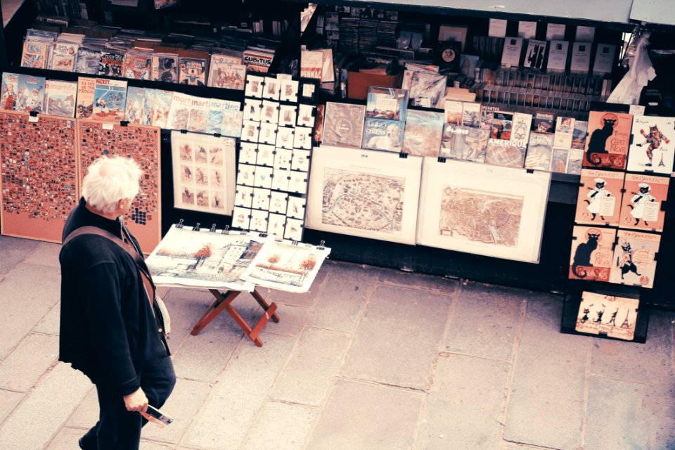 Photo Of An Old Man Looking At The Pictures
