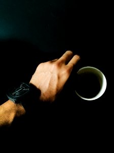 Person Hand And Cup Of Coffee