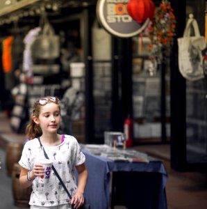 Selective Focus Photo Of Girl Wearing Gray And Black Tree Print Holding Mcdonald Plastic Cup