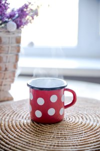 Red White And Black Ceramic Mug On Table photo