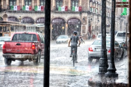 Person Riding A Bicycle During Rainy Day photo