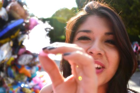 Woman Doing Holding Cotton Candy In Front Of The Camera photo