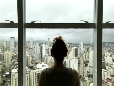 Woman Standing Near Glass Window photo