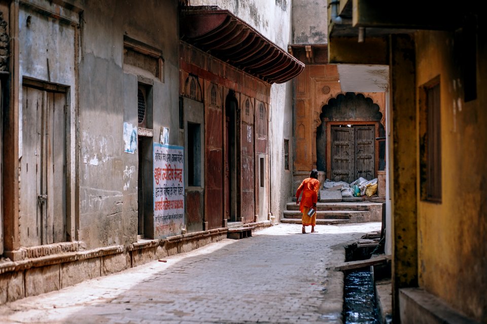 Person Standing Between Two Buildings