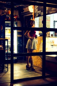 Photo Of A Woman Standing In Front Of The Counter photo