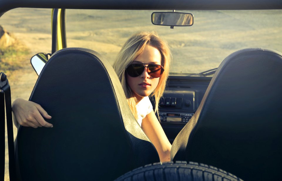 Woman Wearing Sunglasses Riding In Car