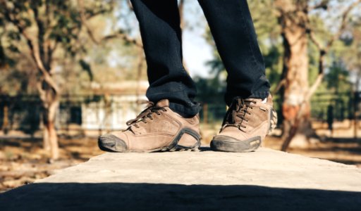 Selective Focus Photography Of Person Wearing Brown Hiking Shoes photo