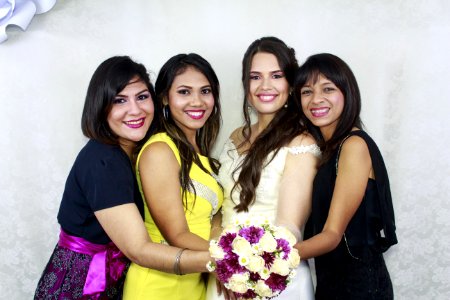 Woman In Beige Wedding Dress Holding Bouquet Flower Together With Other Three Woman In Assorted Colors Of Dresses