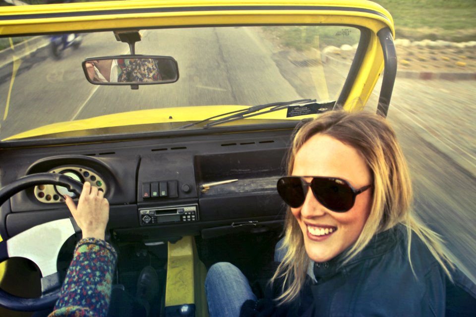 Woman In Black Aviator Sunglasses Sitting On Cars Passenger Seat