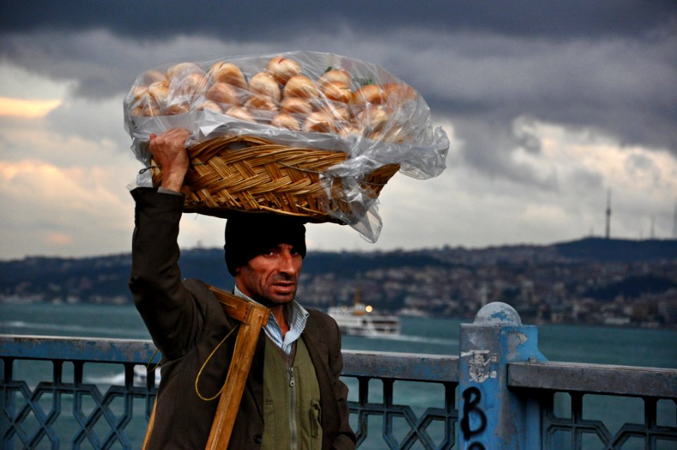 Basket On Mans Head Under Cloudy Sky