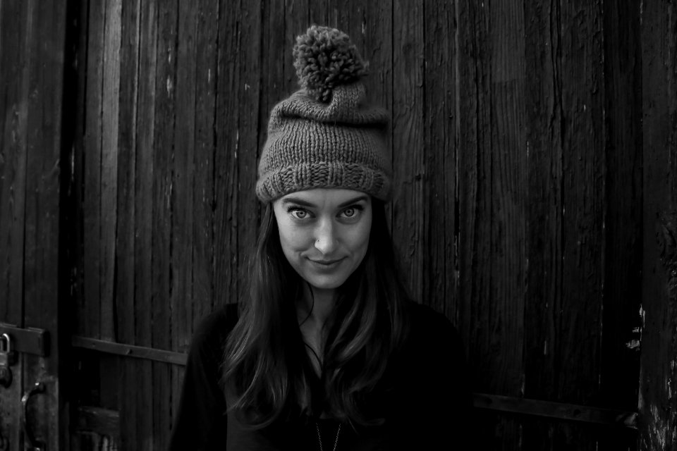 Gray Scale Photo Of Woman Smiling In Front Of The Camera photo