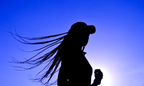 Silhouette Of Woman Wearing Cap photo