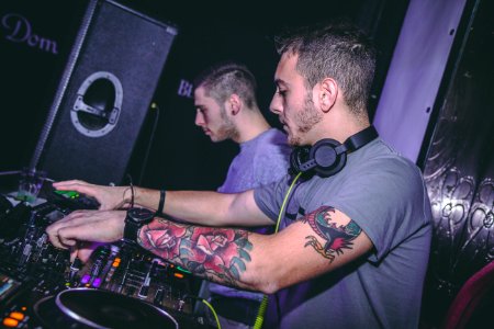 Two Men Standing In Front Dj Mixer