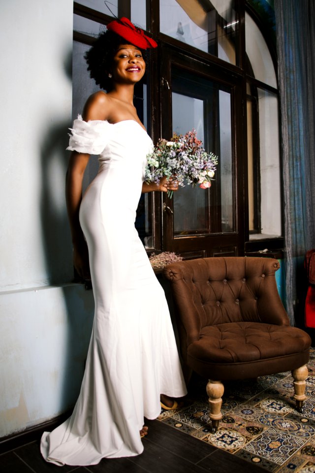 Woman In White Off-shoulder Gown Holding Bouquet Of White Flowers