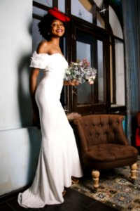 Woman In White Off-shoulder Gown Holding Bouquet Of White Flowers photo