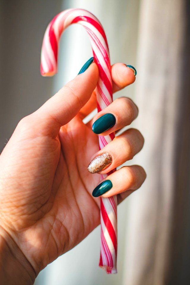 Person Showing White And Red Candy Cane