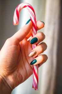 Person Showing White And Red Candy Cane photo