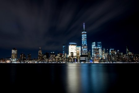High-rise Buildings At Night Near Sea photo