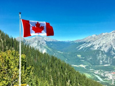 Canada Flag With Mountain Range View photo