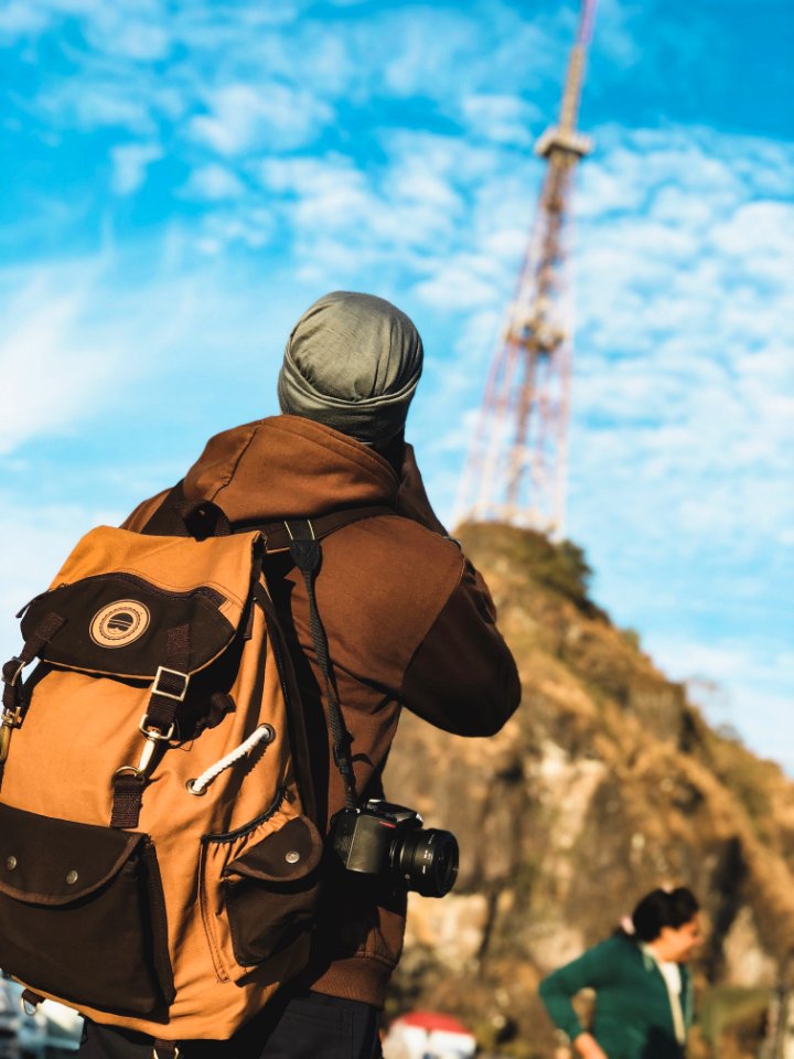 Focus Photography Of Person Wearing Brown And Black Jacket With Brown And Black Backpack