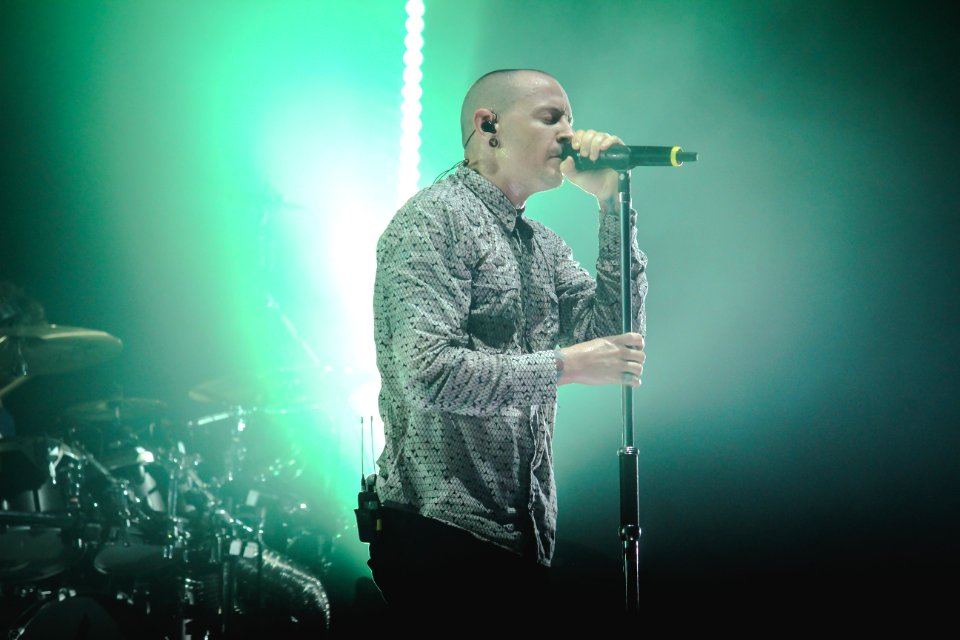Man Wearing Gray Button-up Dress Shirt Holding Black Cordless Microphone With Stand