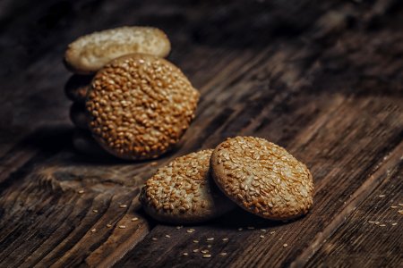 Photography Of Pile Of Cookies With Sesame Seeds On Table photo