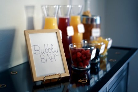 Brown Photo Frame Beside Drinking Glass With Fruit Inside photo