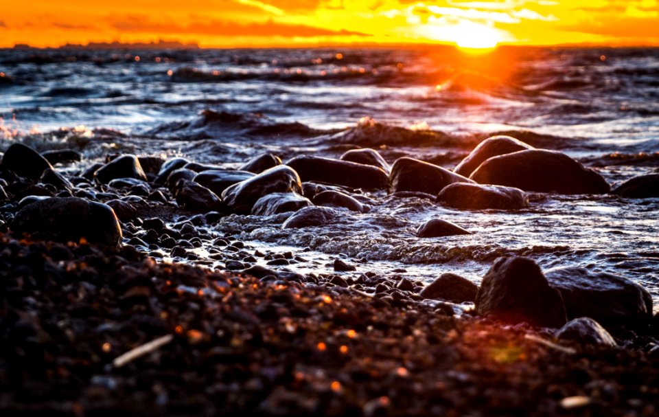Stones Surrounded By Body Of Water During Sunset