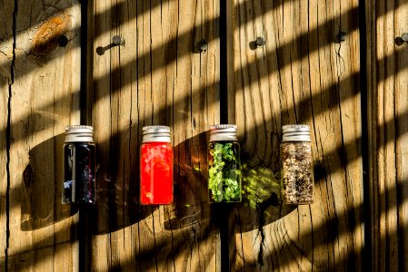 Several Assorted-color Glass Bottles On Table