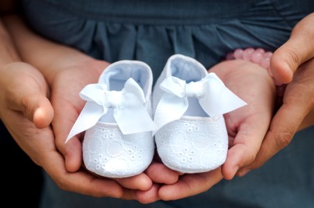 Person Carrying Pair Of Babys White Flats photo