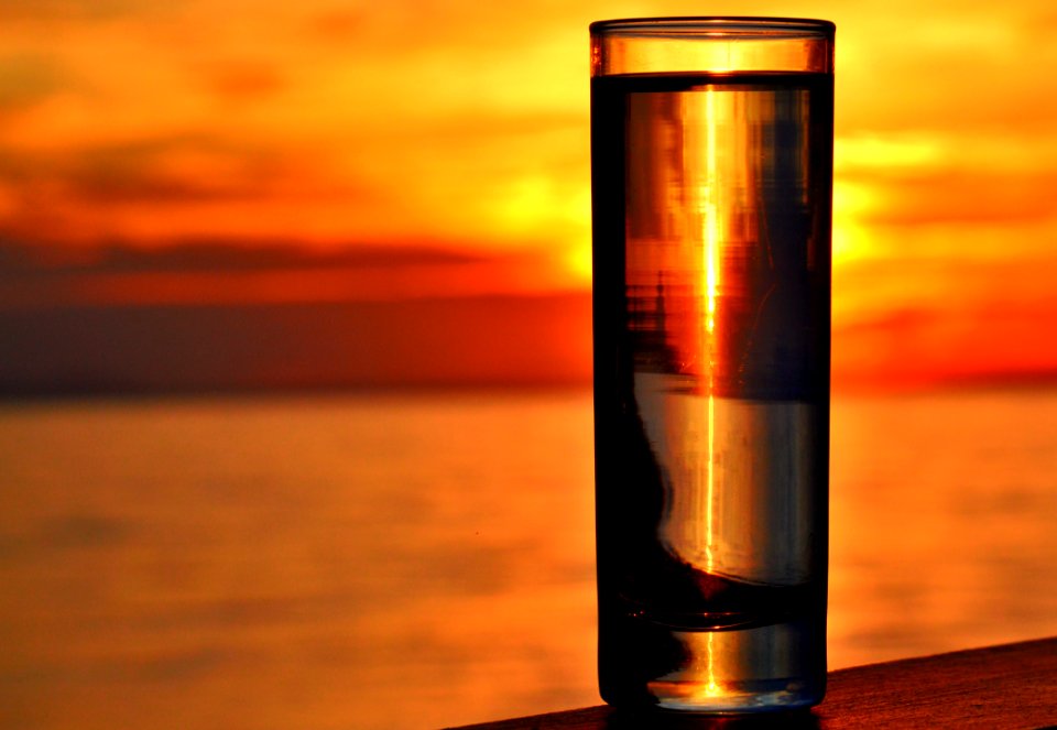 Clear Highball Glass On Brown Surface During Golden Hour