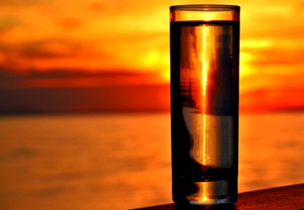 Clear Highball Glass On Brown Surface During Golden Hour photo