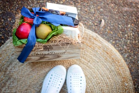 Red And Green Fruits Beside White Box On Brown Wooden Box