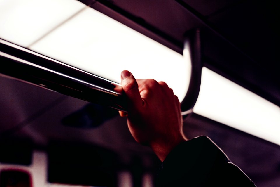 Humans Hand Holding On Silver Handle Bar Photography