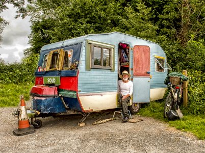 Photo Of A Man In White Long-sleeved Top On Blue And White Pop-up Camper photo