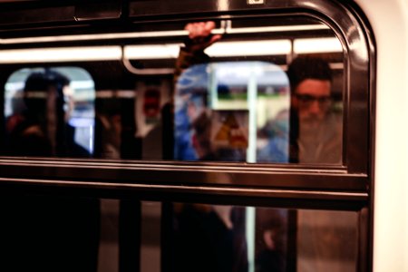 Man Standing Inside Train Waiting To Stop photo
