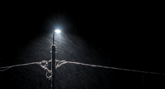 Black Electric Lamp Post With Lighted Lamp During Nighttime photo