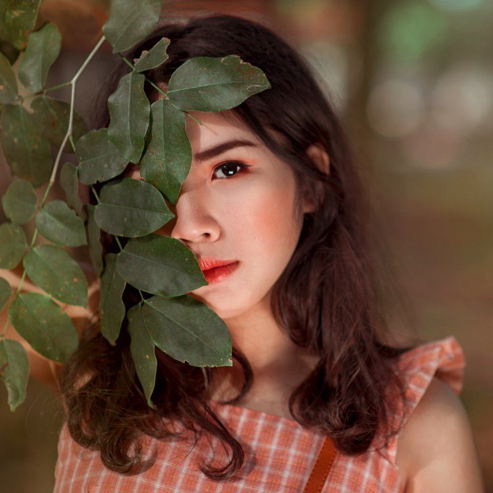Girl In Orange And White Gingham Sleeveless Dress Close-up Photo