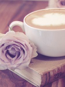 Photography Of Flower Beside Coffee On Top Of Book photo