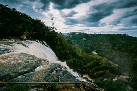 Waterfalls Beside Green High Trees Under White Sky At Daytime