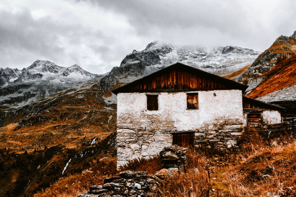 White And Brown House Near Snow Capped Mountains