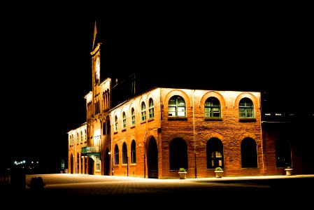 Brown Brick Building With Lights During Night Time photo