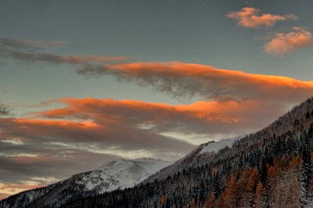 A View Of Snowy Mountains Under Cloudy Sky