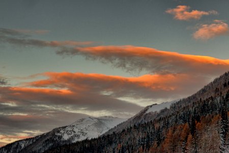 A View Of Snowy Mountains Under Cloudy Sky photo