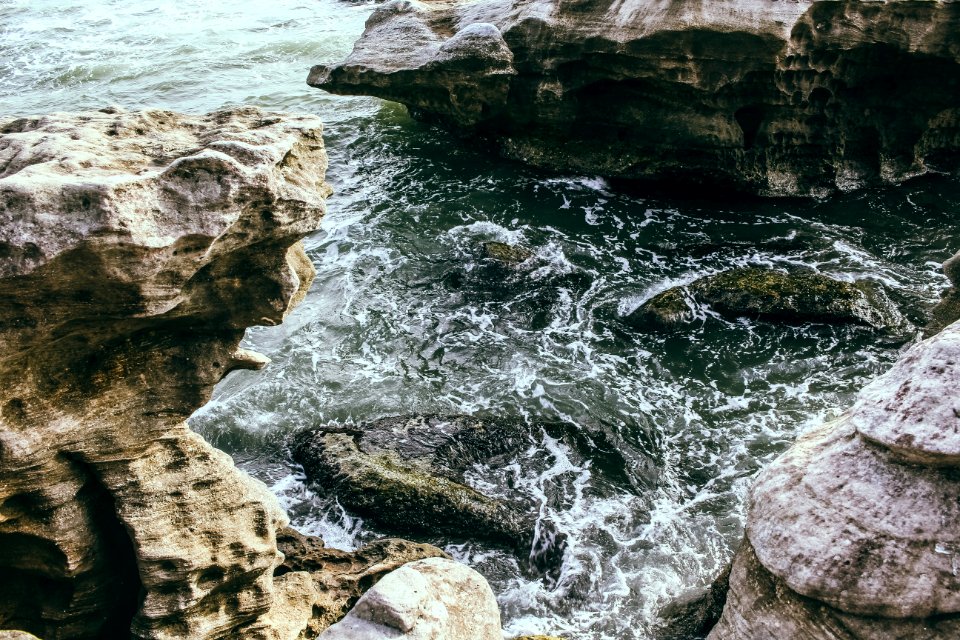 Brown Rock Formation Near Body Of Water photo