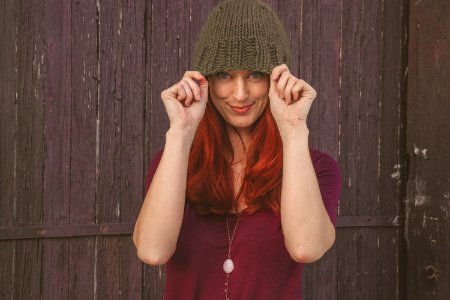 Woman Wearing Maroon Scoop-neck Shirt With Brown Knit Cap photo